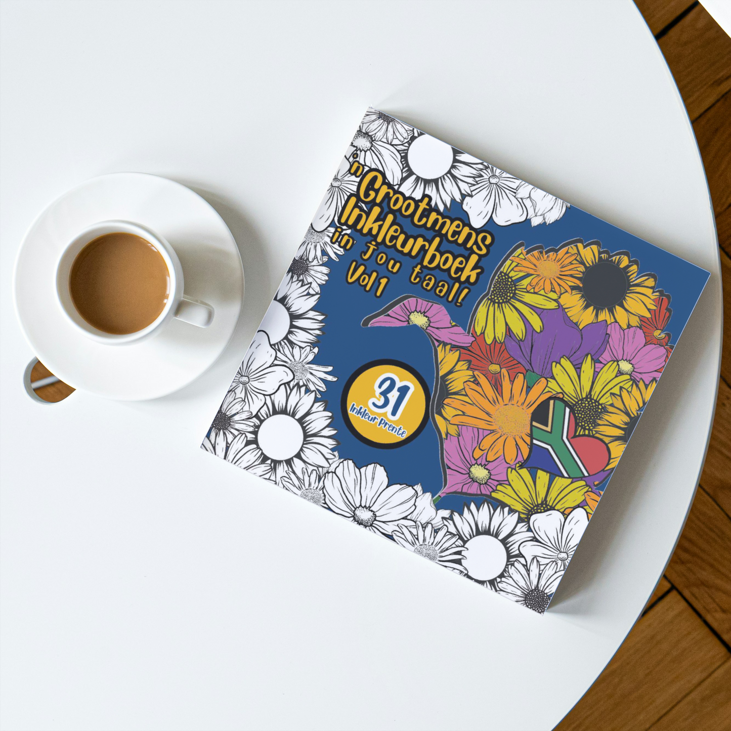 Coloring book with floral designs on a white surface next to a cup of coffee.
