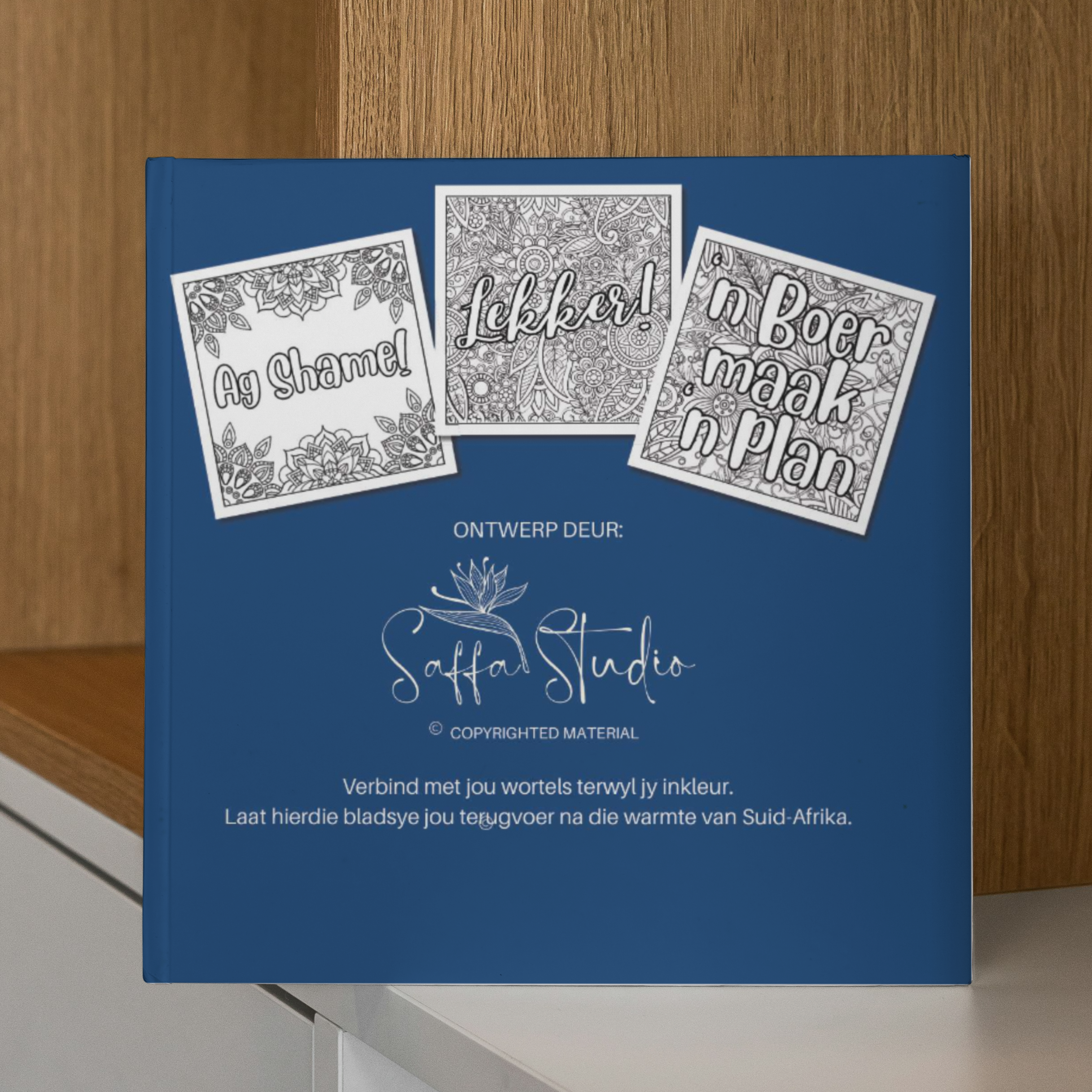 Back of the book with white text and graphics on a wooden shelf.